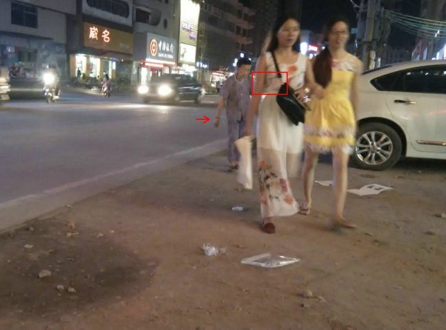 请注意阿婆的那只手和阿婆左臂与长裙女子腰胸间的情景
